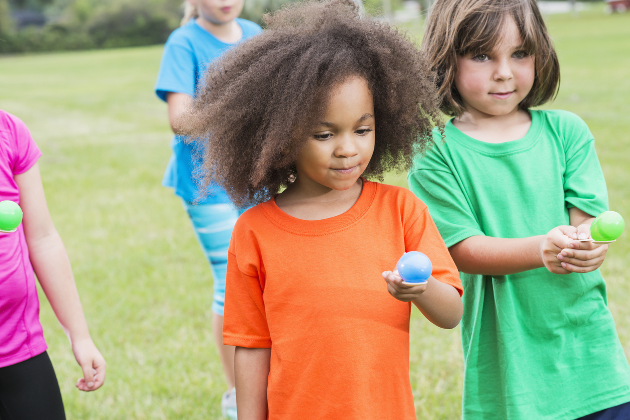 Group of children in egg spoon race