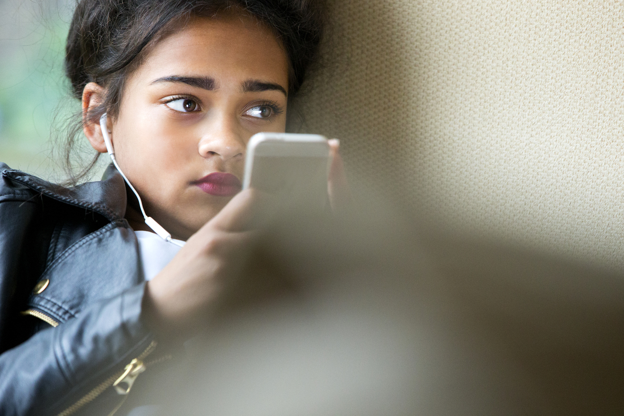 Teenager on her mobile phone