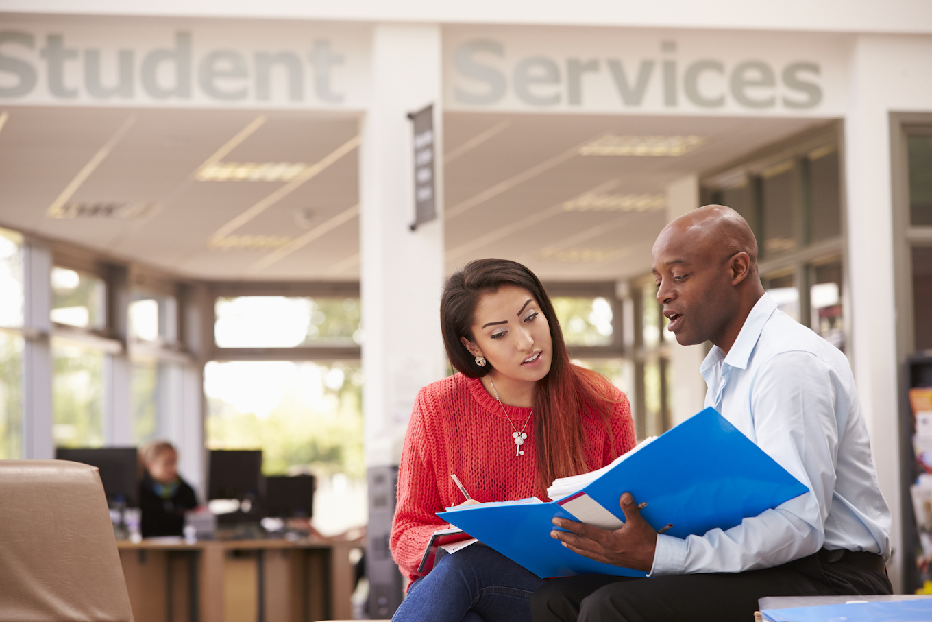 College Student Having Meeting With Tutor To Discuss Work