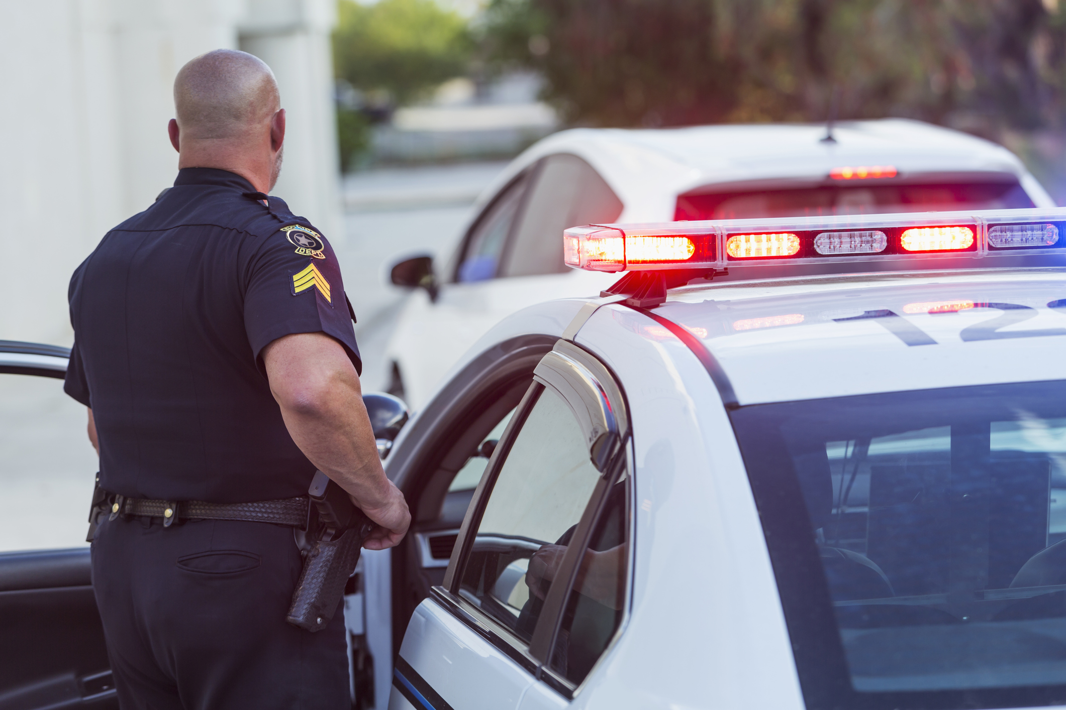 Police officer getting out of cruiser