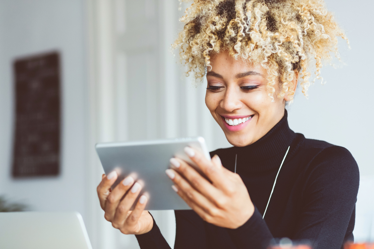 Afro american young woman using digital tablet in an office