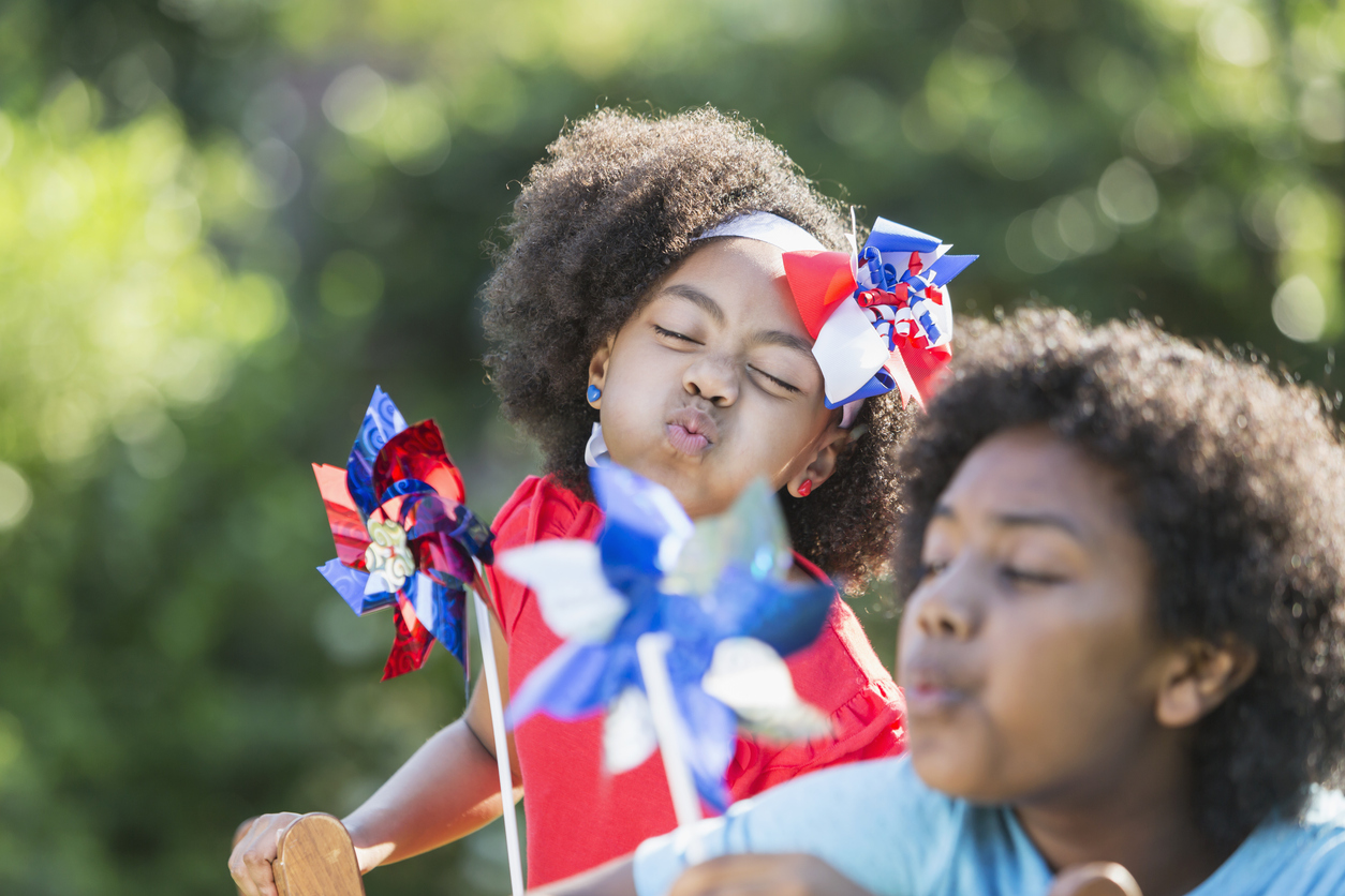 Mixed race children celebrating American patriotic event