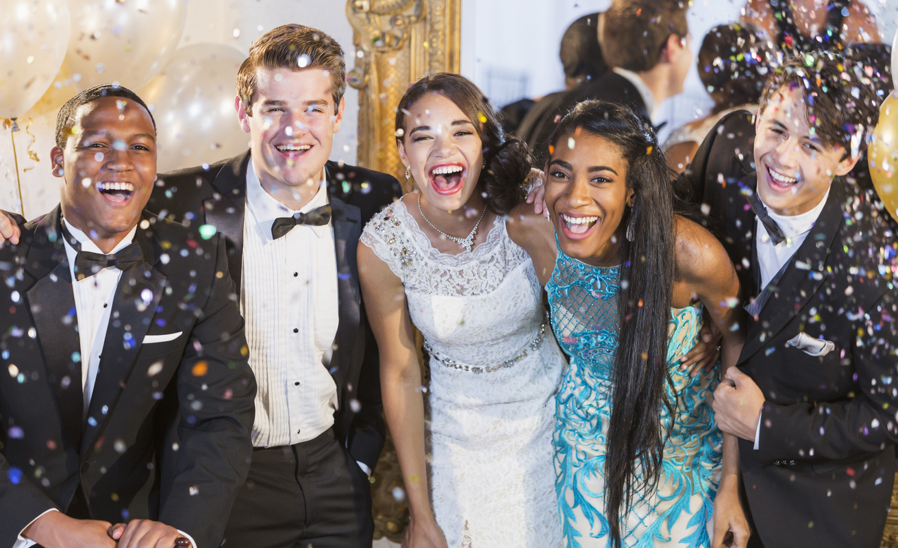 Teenagers and young adults in formalwear at party