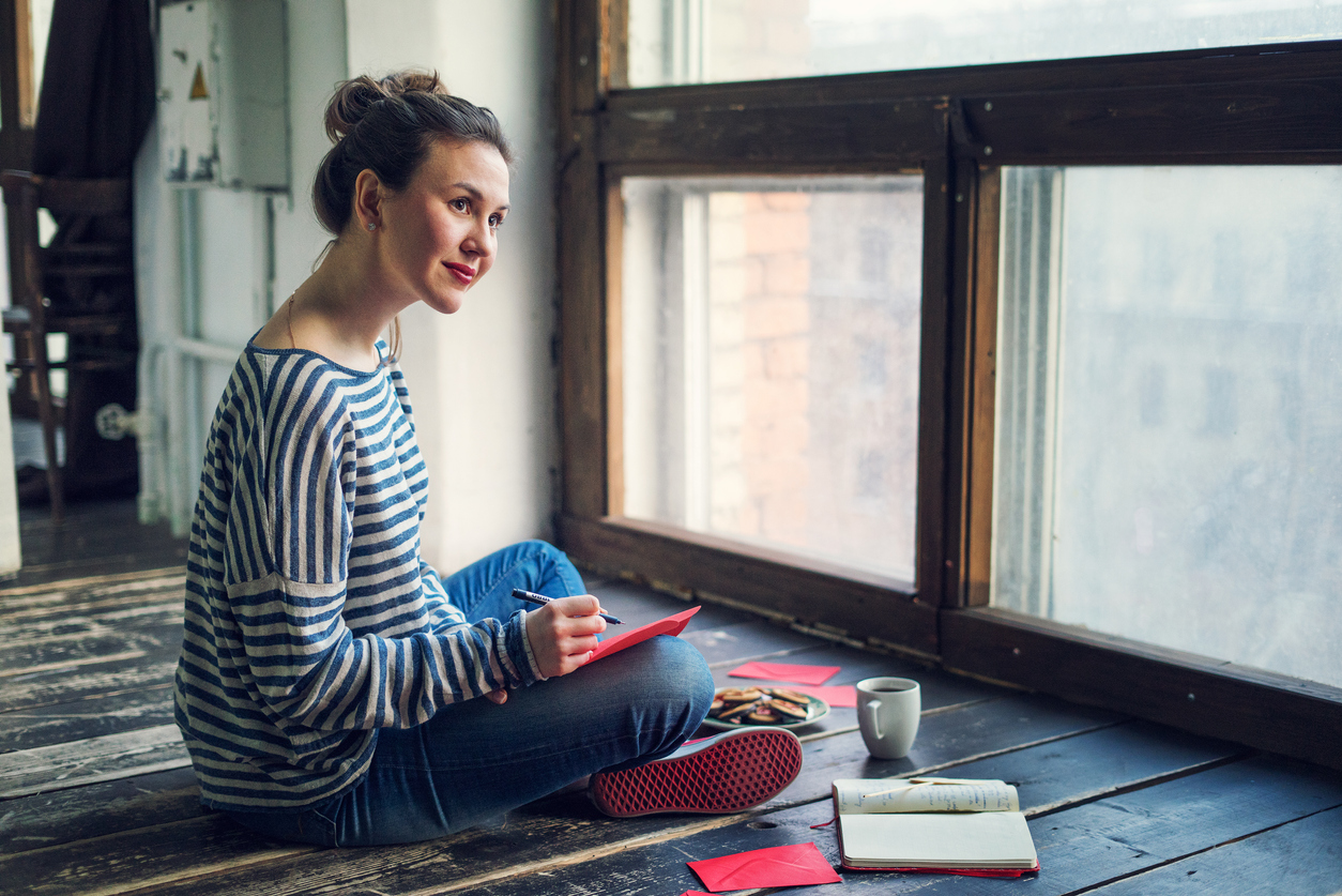 Young woman writing a valentine card