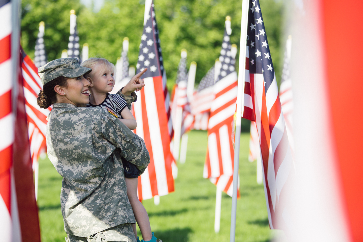 American female soldier with 3 year old girl