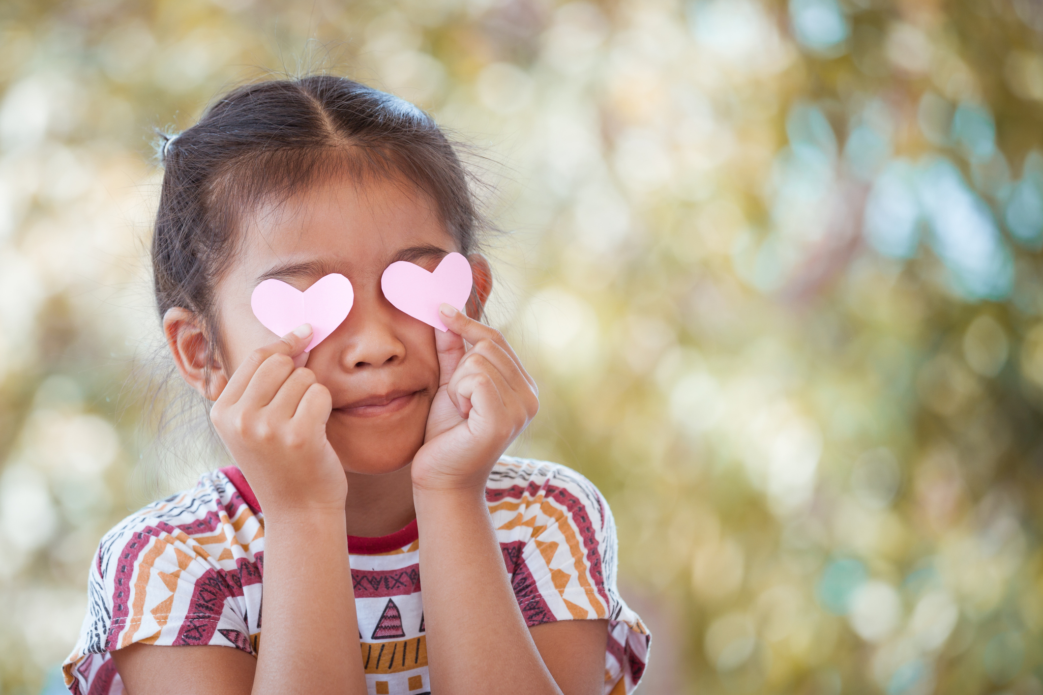 Cute asian little girl with hearts on the eyes