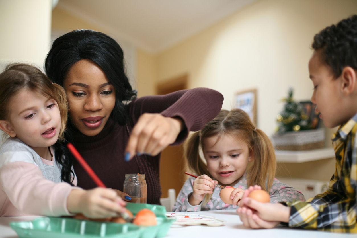 Woman with three child. African American woman with three child prepare for Easter.