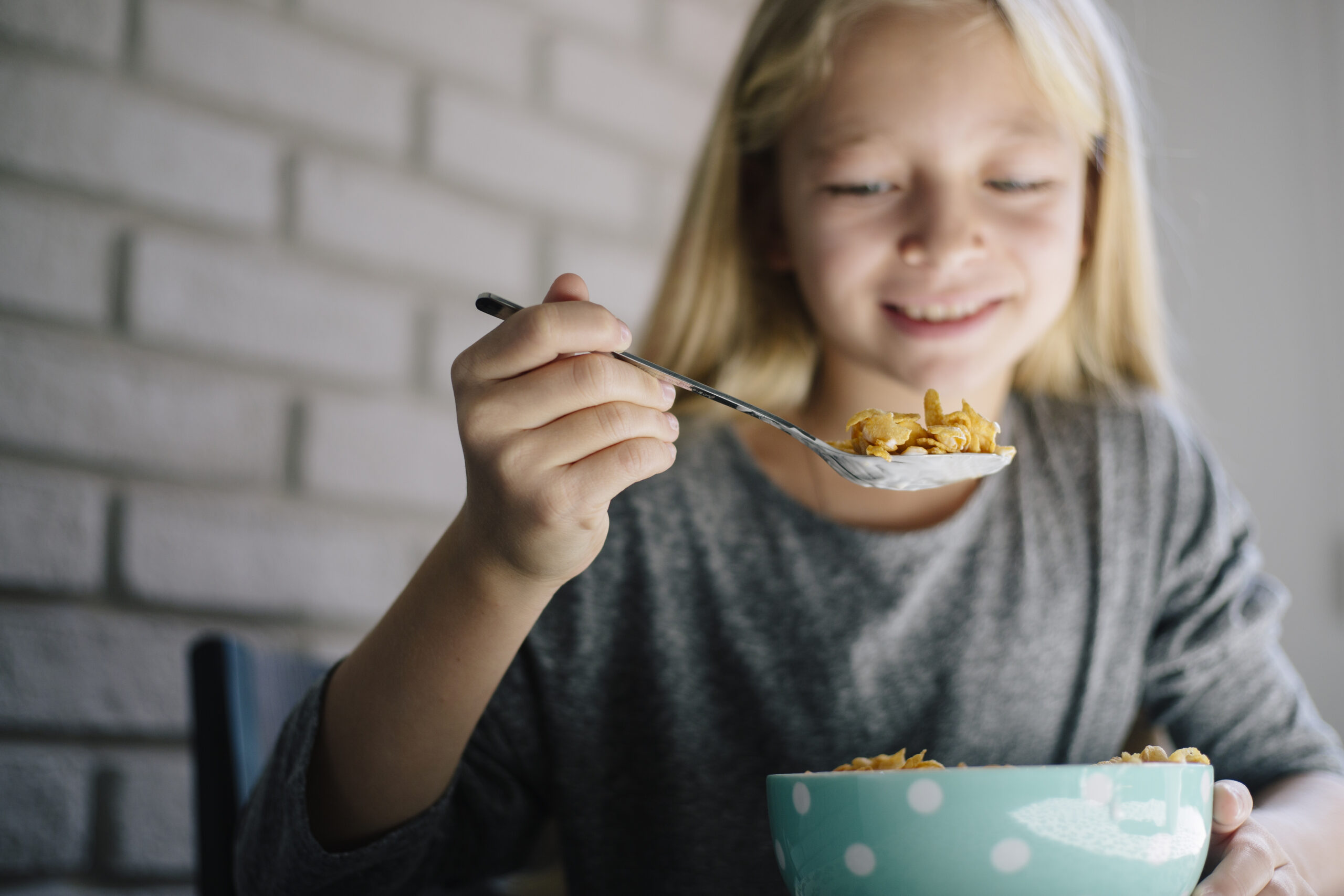 Girl having corn-flex for breakfast