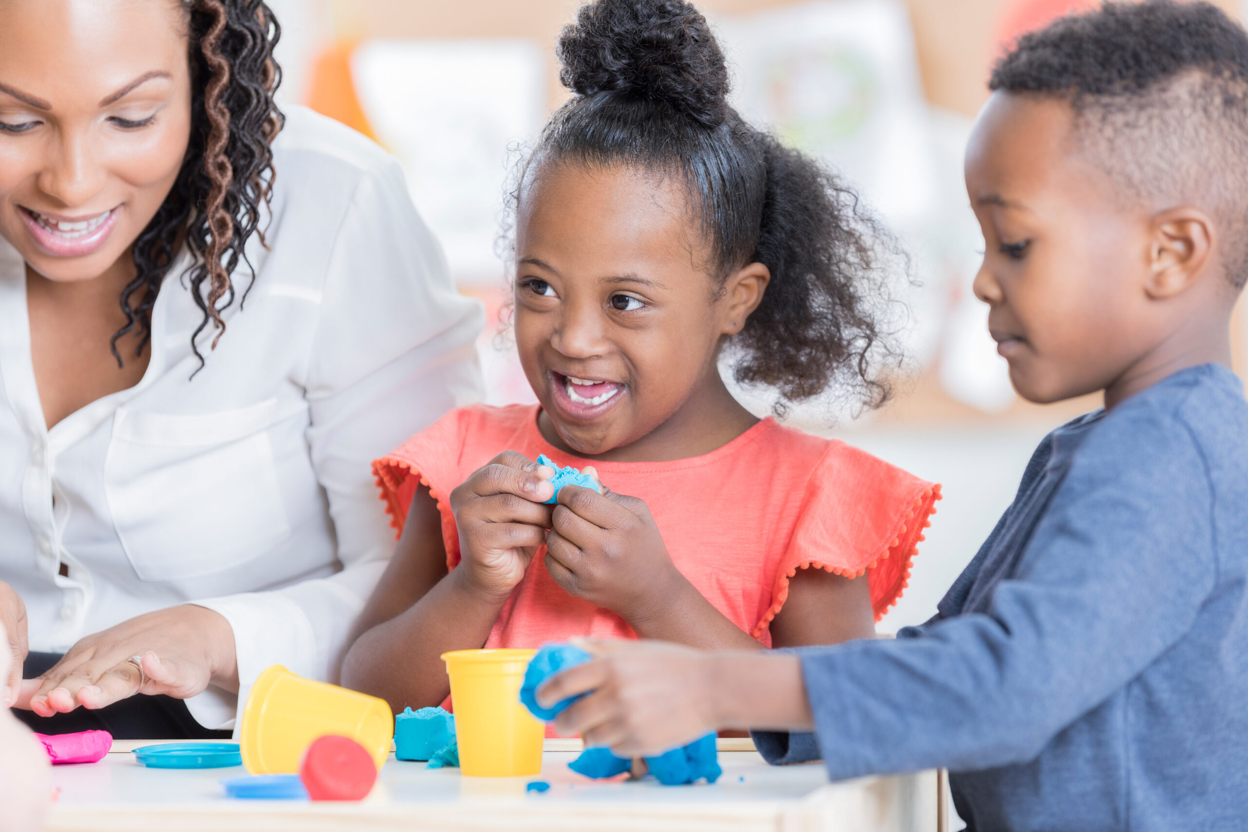 Preschool students play with modeling clay