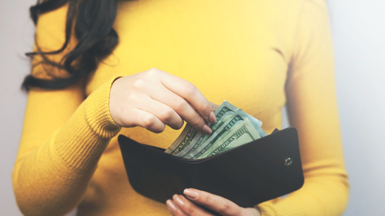 Woman pulling money from wallet