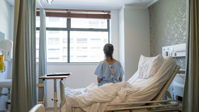 Woman sitting on hospital bed