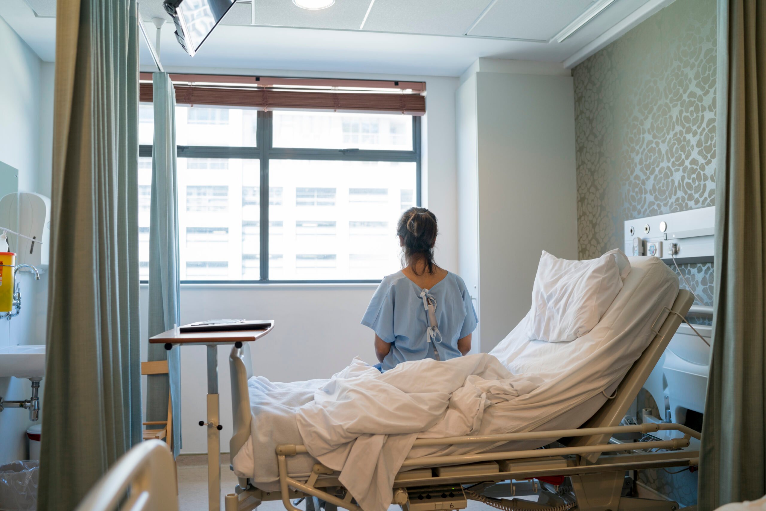 Woman sitting on hospital bed