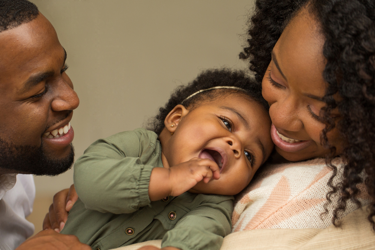 Happy African American family with their little girl.