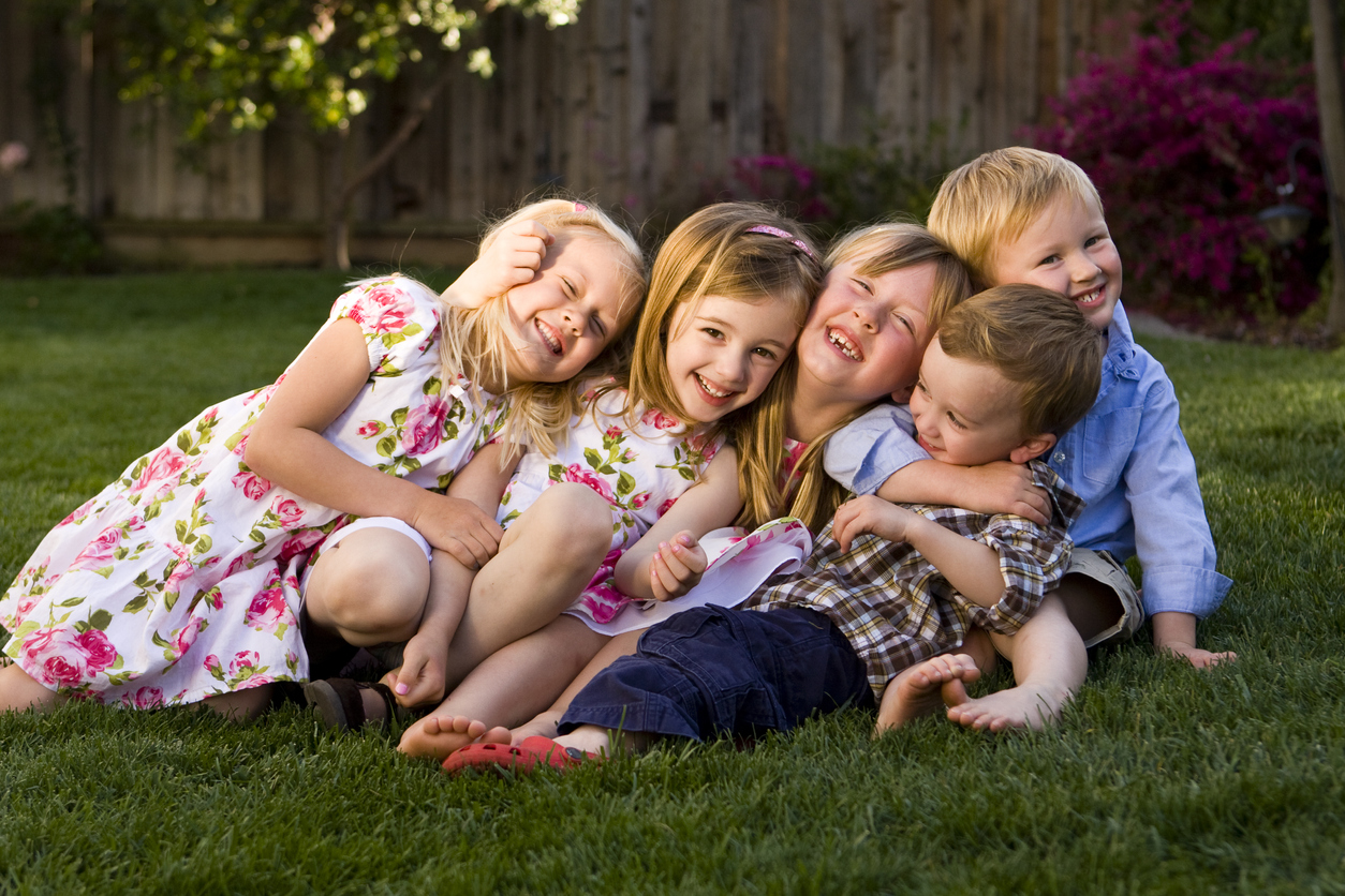 Group of Children Laughing, Hugging and Smiling