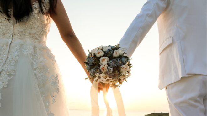 Bride and groom holding hands