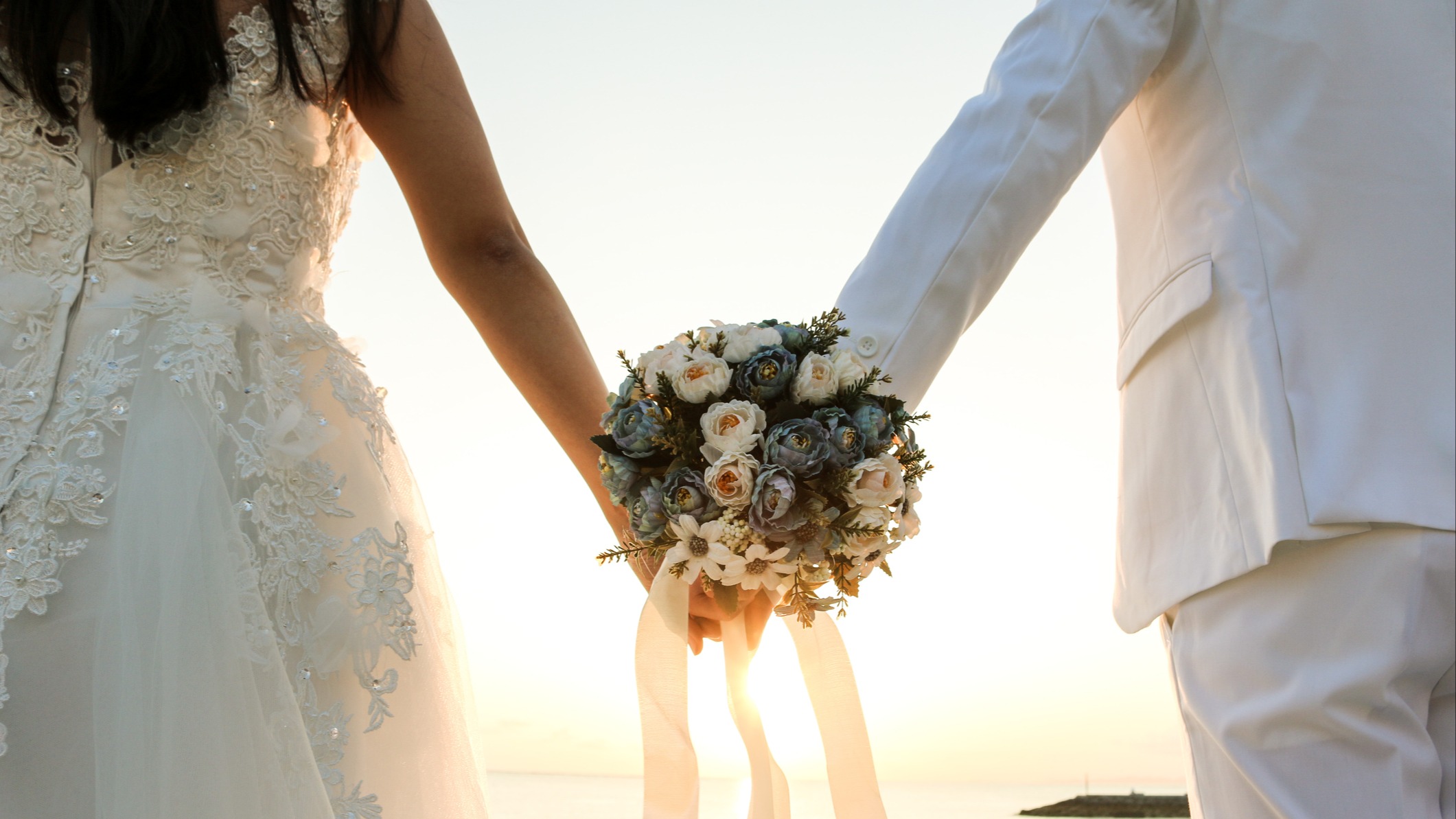 Bride and groom holding hands