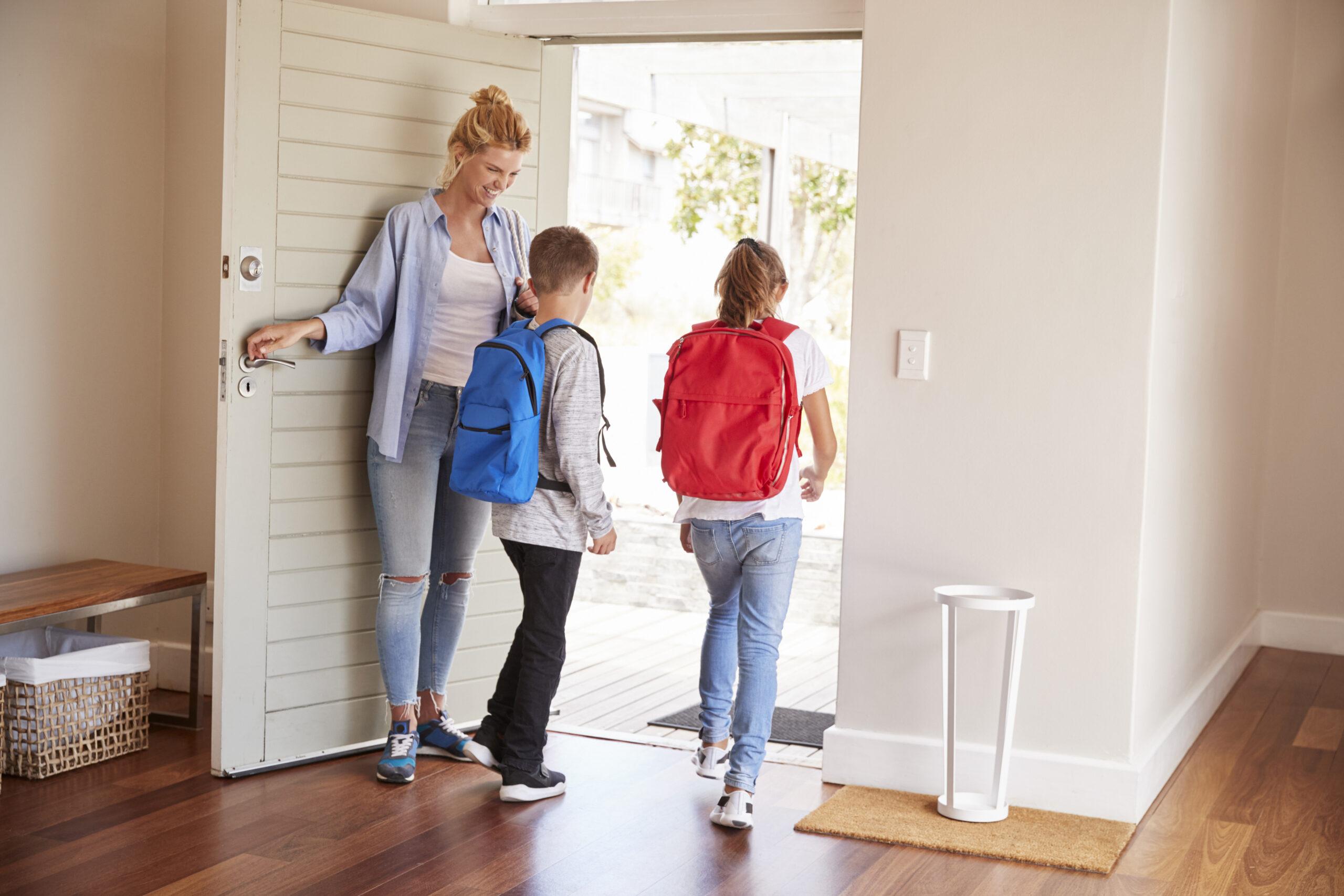 Mother Getting Children Ready To Leave House For School