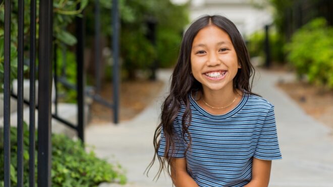 Portrait of a young happy Asian girl smiling.