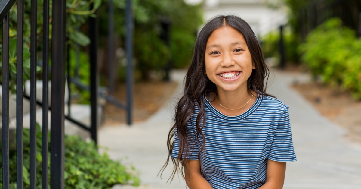 Portrait of a young happy Asian girl smiling.