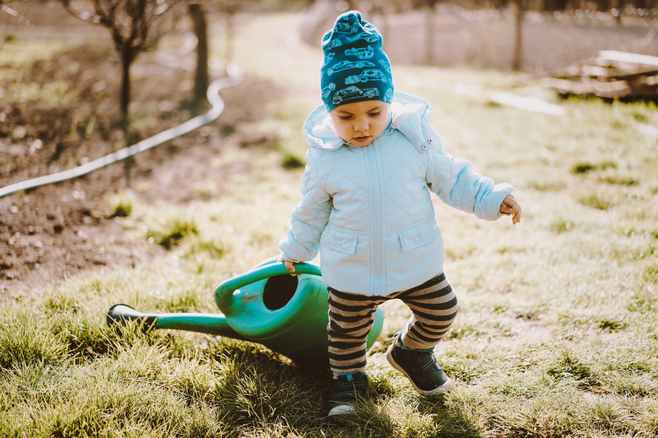 little-toddler-baby-boy-walking-with-big-watering-can-in-garden-adorable-child-helping-parents-to_t20_9kglk2.jpg