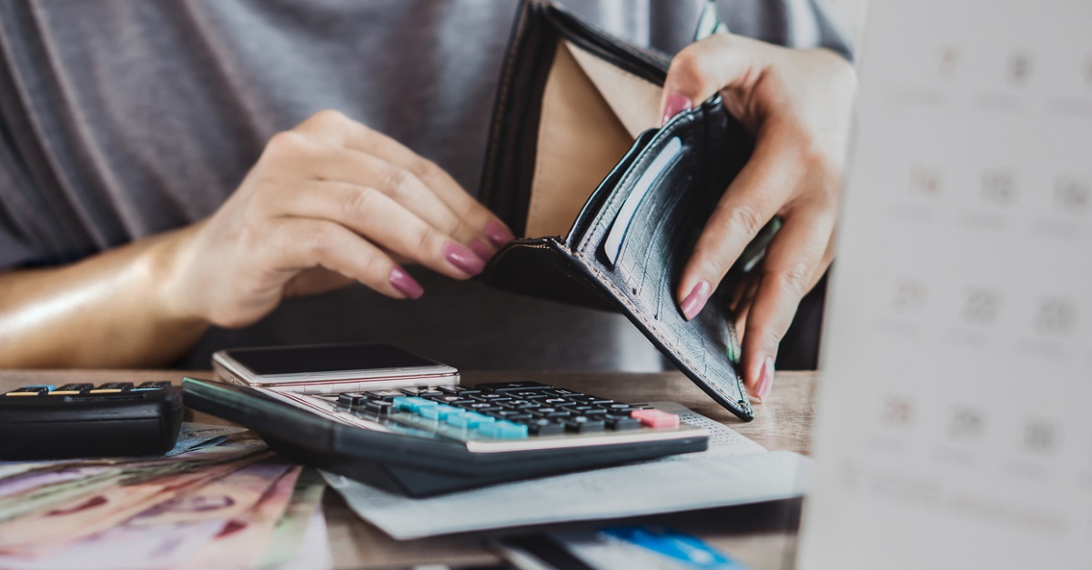 poor woman hand open empty purse looking for money for credit card debt