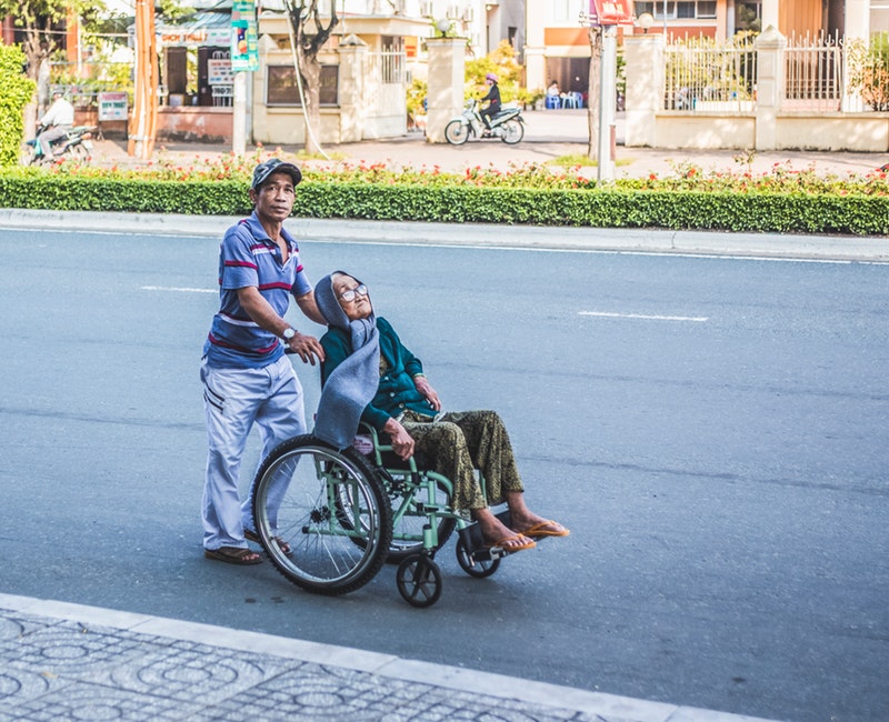 man-pushing-a-woman-sitting-on-wheelchair-3101214.jpg