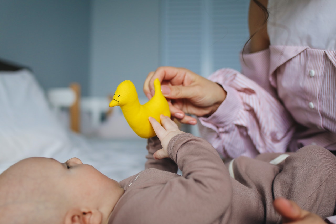 mommy-playing-rubber-duckie-with-her-baby-3875202.jpg