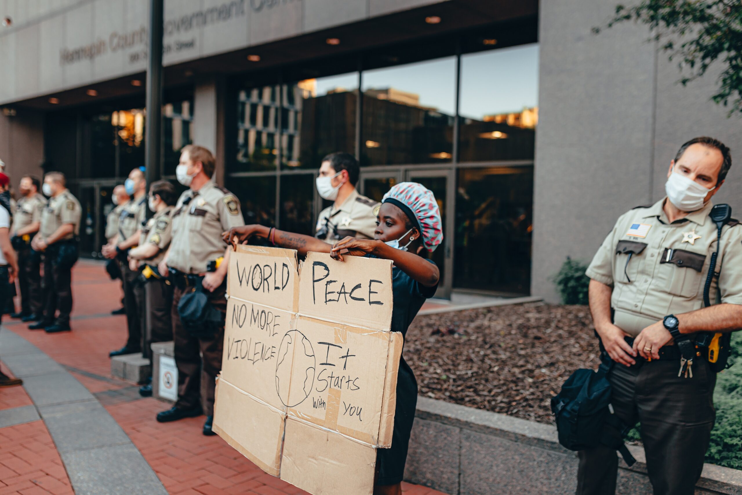 person-protesting-next-to-cops-4508667.jpg