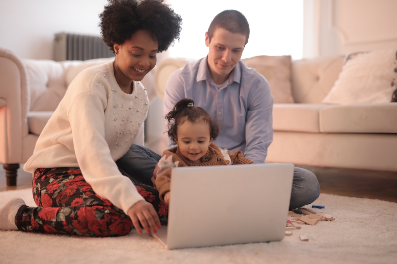 photo-of-family-sitting-on-floor-while-using-laptop-3818963.jpg