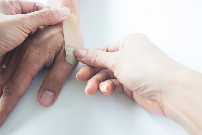 plaster-on-mans-hand-womans-hands-using-bandage-on-mans-hand-after-accident-healthcare_t20_9lpOLN.jpg