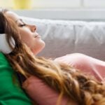 Relaxing on a couch with headphones