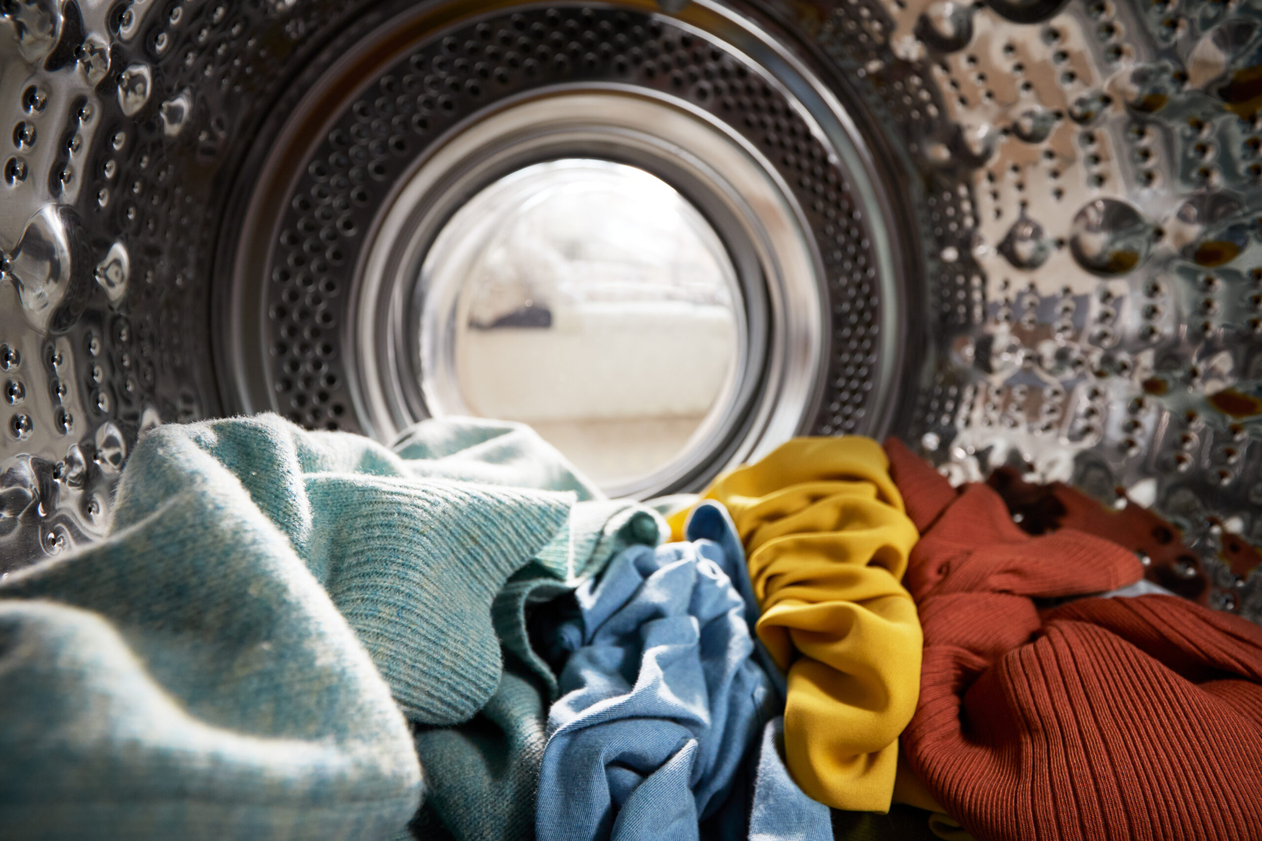 View,Looking,Out,From,Inside,Washing,Machine,Filled,With,Laundry