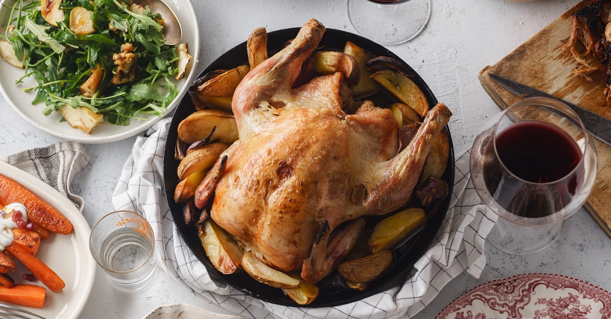 Big festive dinner with roasted chicken and various garnishing. Overhead view, celebration concept