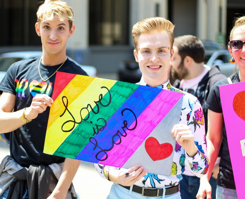 three-men-holding-assorted-painted-love-is-love-banner-2306779.jpg