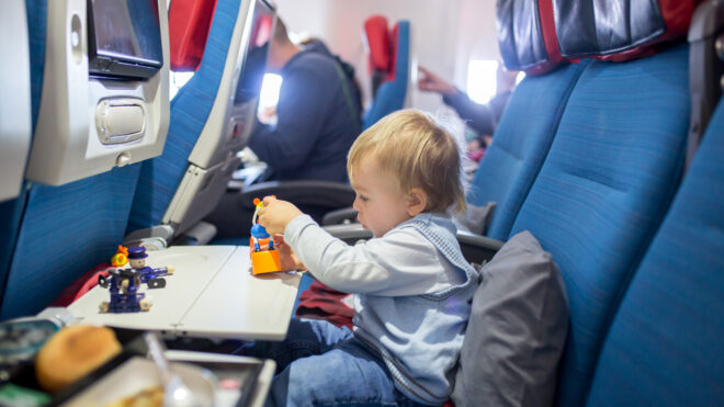 Toddler playing with toys on plane