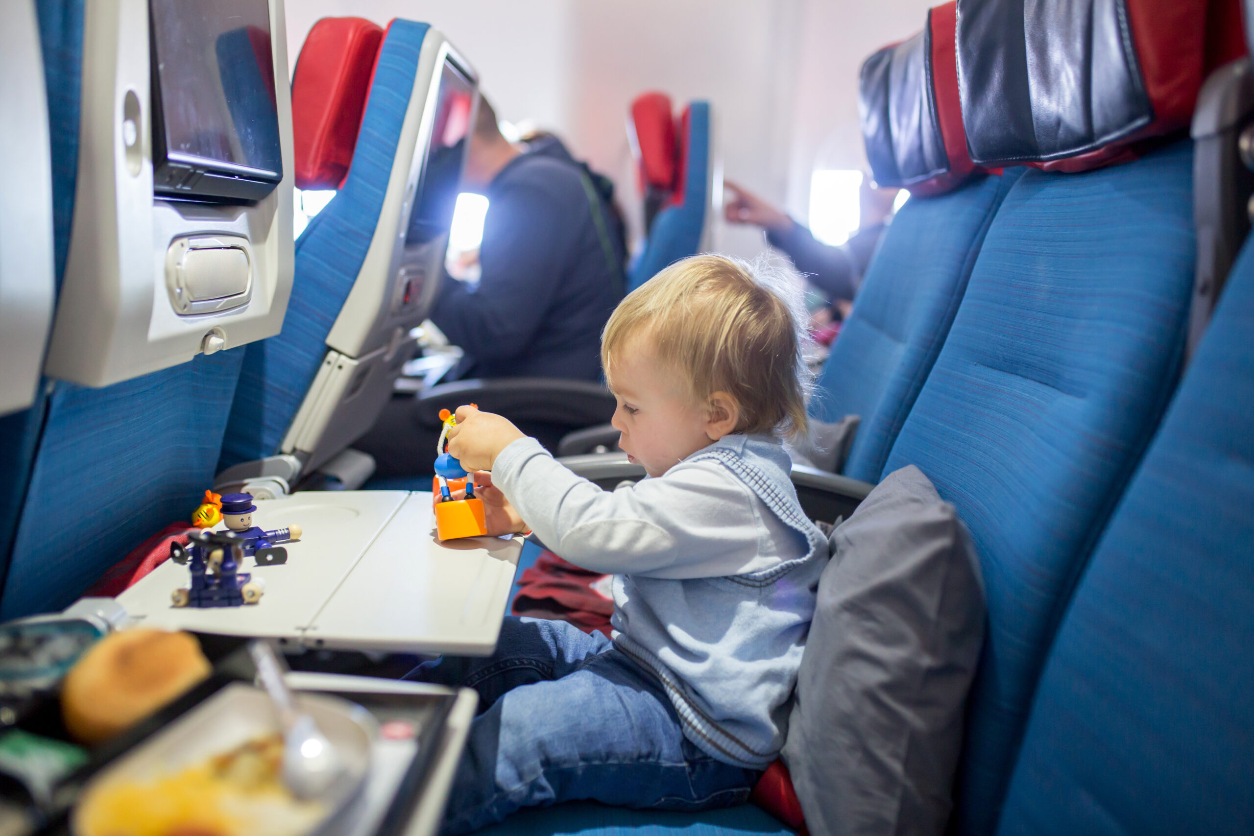 Toddler playing with toys on plane