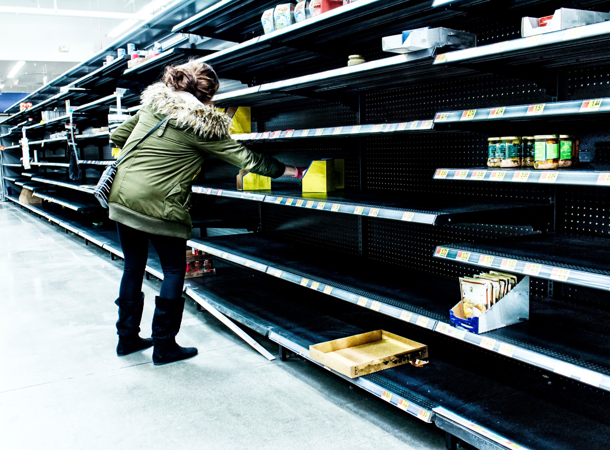 woman-grabbing-remaining-food-from-mostly-empty-shelves-during-coronavirus-pandemic_t20_pLydeW.jpg