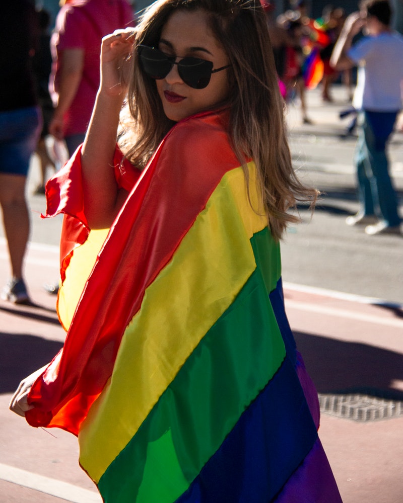 woman-holding-rainbow-coloured-flag-2577852.jpg