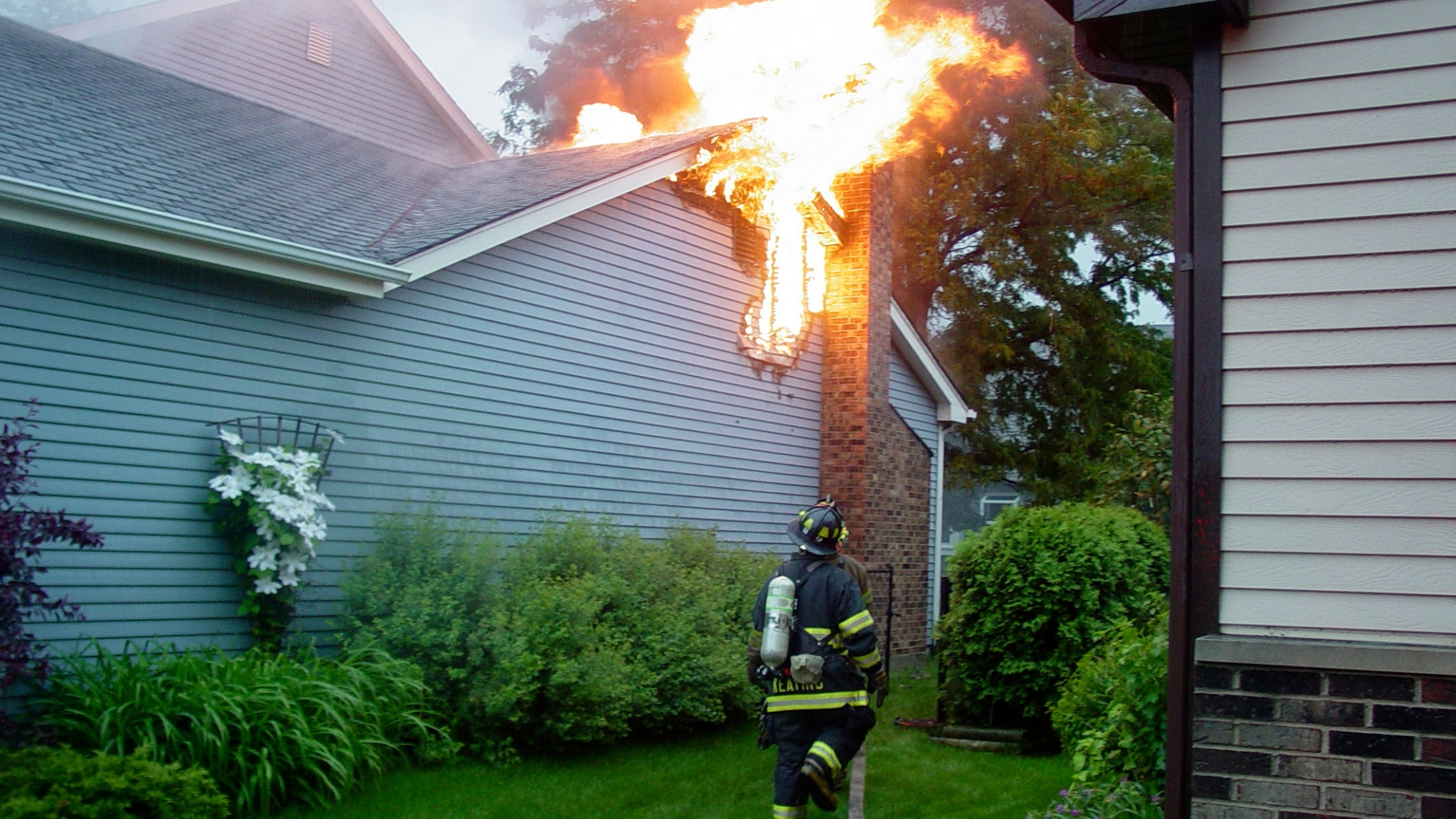 woman-watches-house-burn