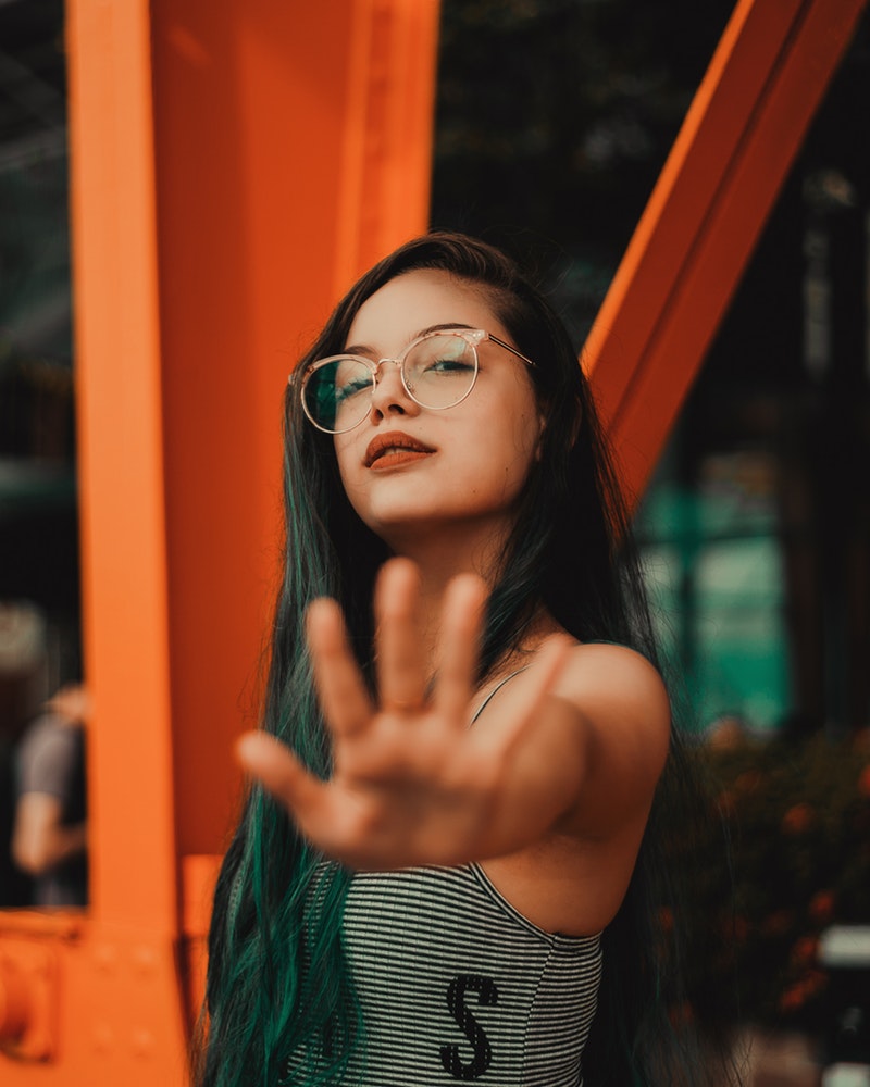 woman-wearing-eyeglasses-standing-near-post-1998831.jpg