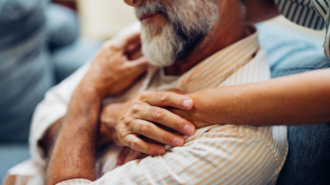 Older man being embraced