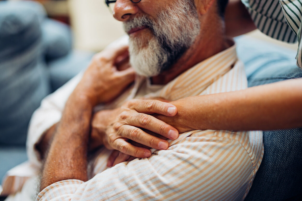 Older man being embraced