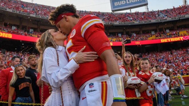 Chiefs quarterback Patrick Mahomes kisses his wife, Brittany Mahomes, before kickoff of a game at GEHA Field at Arrowhead Stadium.