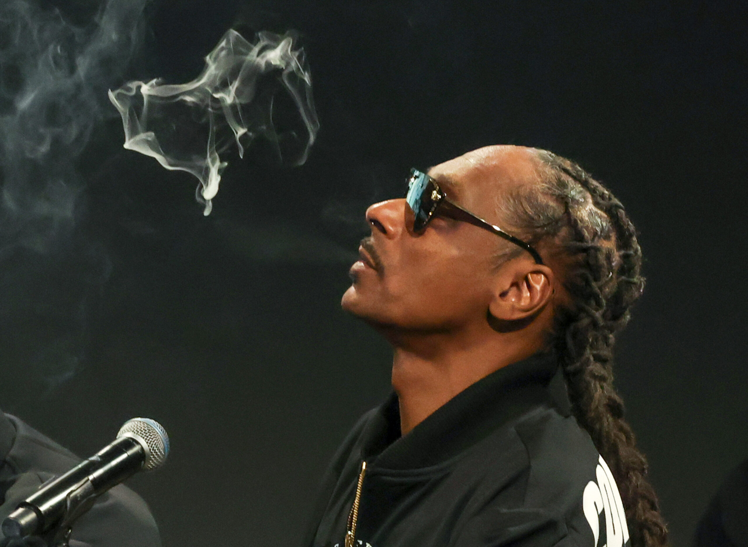 Snoop Dogg blows smoke as he participates in a live episode of the podcast "Drink Champs" at ComplexCon 2024 at the Las Vegas Convention Center on Nov. 16, 2024, in Las Vegas. (Ethan Miller/Getty Images/TNS)