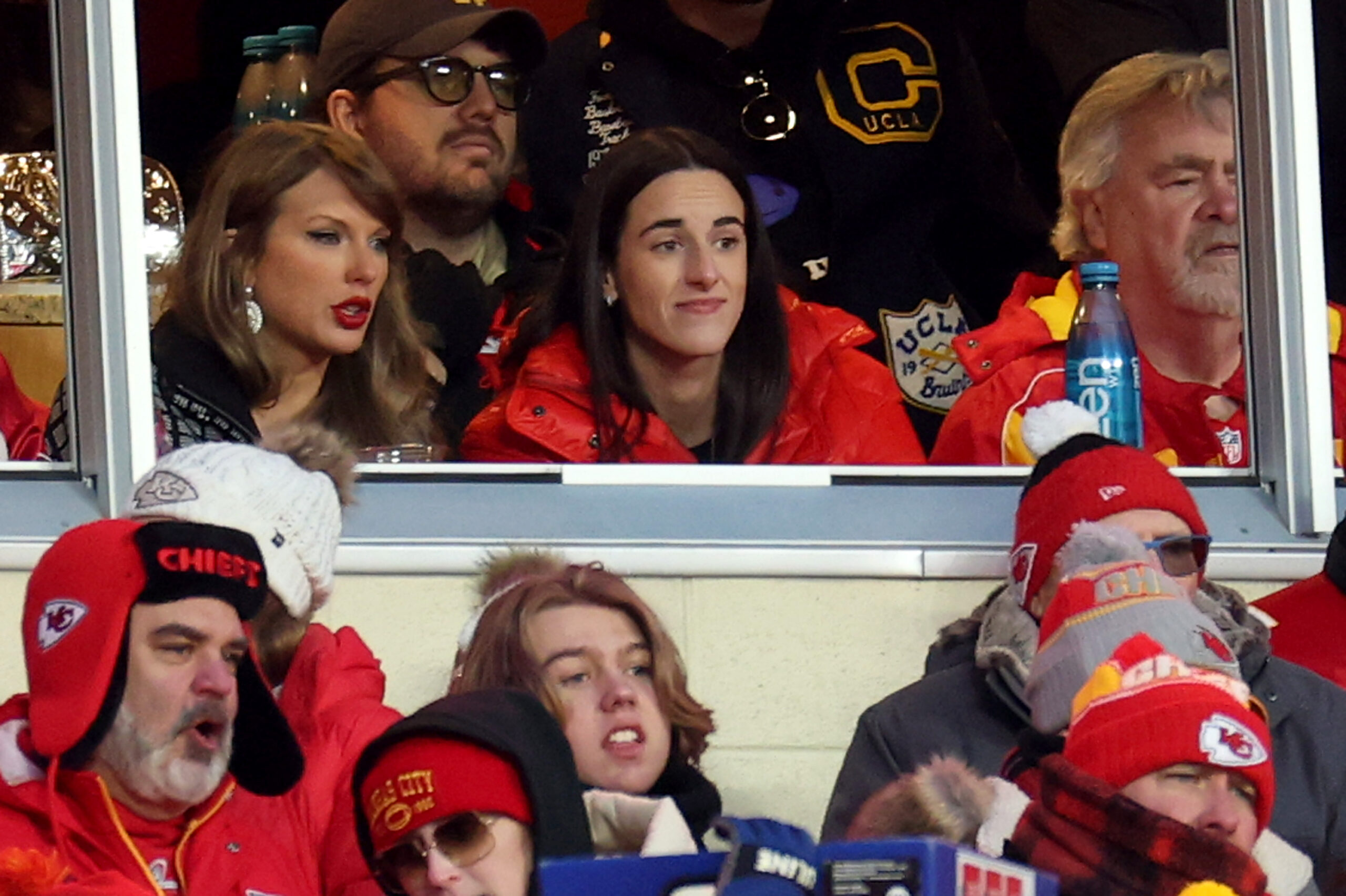 Singer-songwriter Taylor Swift, left, talks with Caitlin Clark, right, of the Indiana Fever during the second half in the AFC Divisional Playoff between the Houston Texans and Kansas City Chiefs at GEHA Field at Arrowhead Stadium on Saturday, Jan. 18, 2025, in Kansas City, Missouri. (Jamie Squire/Getty Images/TNS)