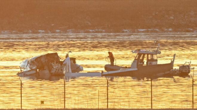 Part of the wreckage is seen as rescue boats search the waters of the Potomac River American Airlines flight 5342 on approach to Reagan National Airport crashed into the river near Washington, DC, on January 30, 2025. A regional jet from Kansas crashed into Washington's Potomac River after colliding mid-air with a military helicopter near Reagan National Airport, officials said January 29, prompting a major emergency response and grounding all flights. (Photo by Andrew CABALLERO-REYNOLDS / AFP) (Photo by ANDREW CABALLERO-REYNOLDS/AFP via Getty Images)