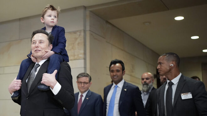 Tesla CEO Elon Musk, chair of the Department of Government Efficiency (DOGE), carries his son on his shoulders at the U.S. Capitol while walking with businessman Vivek Ramaswamy (blue tie) and Speaker of the House Mike Johnson (red tie), R-La., on Dec. 5, 2024, in Washington, D.C. (Andrew Harnik/Getty Images/TNS)