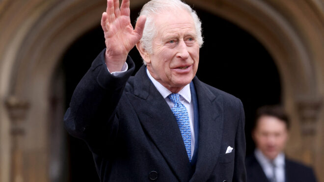 King Charles III waves as he leaves after attending the Easter Mattins Service at at St. George's Chapel, Windsor Castle on March 31, 2024, in Windsor, England. King Charles and Prince William say they will not attend the funeral of former U.S. President Jimmy Carter. (Hollie Adams/WPA Pool/Getty Images/TNS)