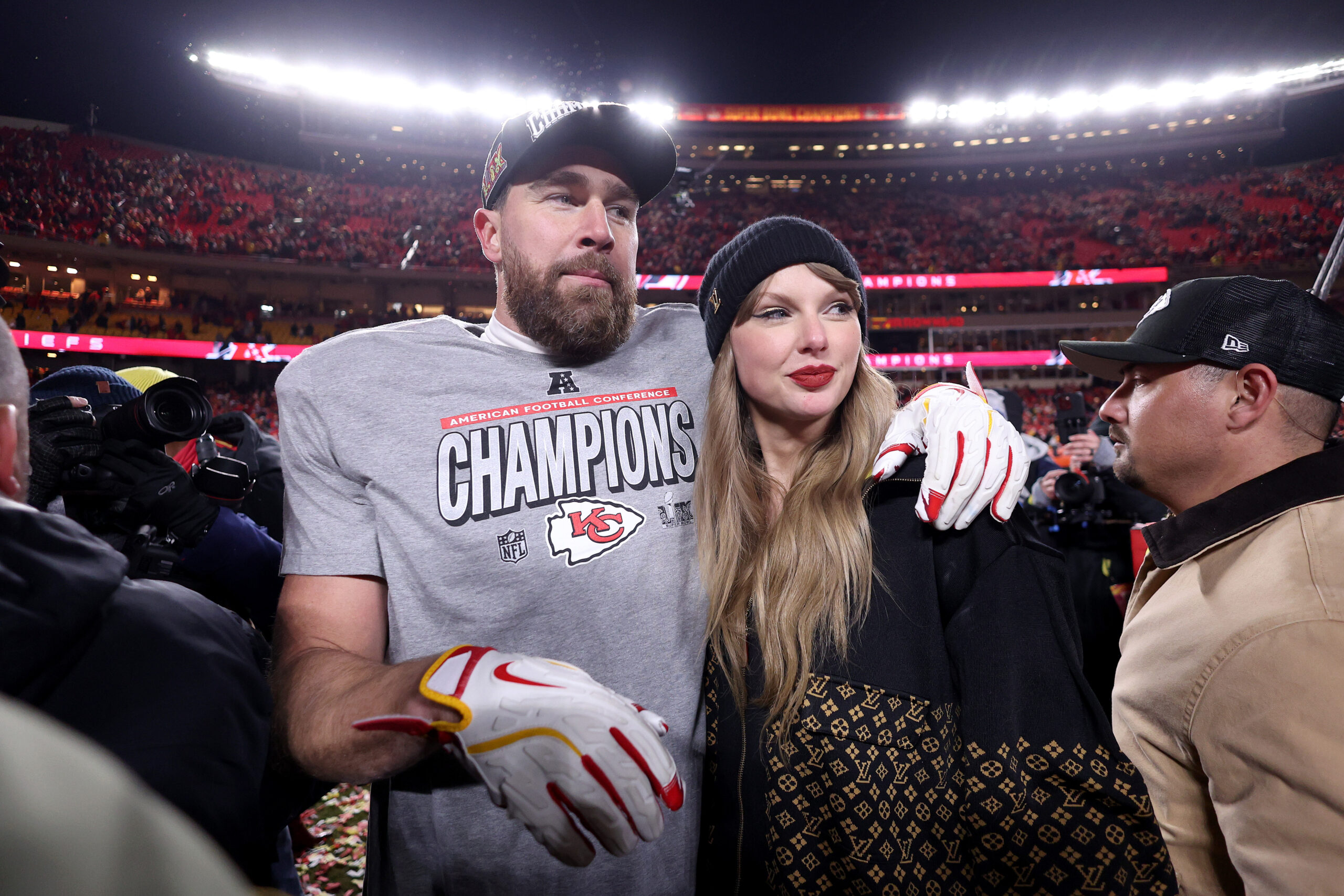 KANSAS CITY, MISSOURI - JANUARY 26: Taylor Swift celebrates with Travis Kelce #87 of the Kansas City Chiefs after defeating the Buffalo Bills 32-29 in the AFC Championship Game at GEHA Field at Arrowhead Stadium on January 26, 2025 in Kansas City, Missouri. (Photo by Jamie Squire/Getty Images)