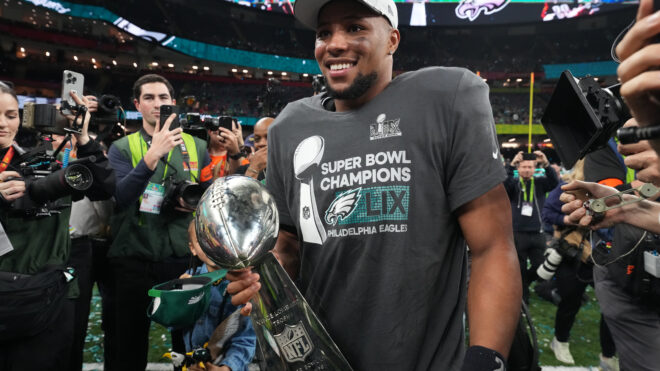 Football: Super Bowl LIX: Philadelphia Eagles Saquon Barkley (26) in action, victorious with the Vince Lombardi trophy following game vs Kansas City Chiefs at Caesar's Superdome.